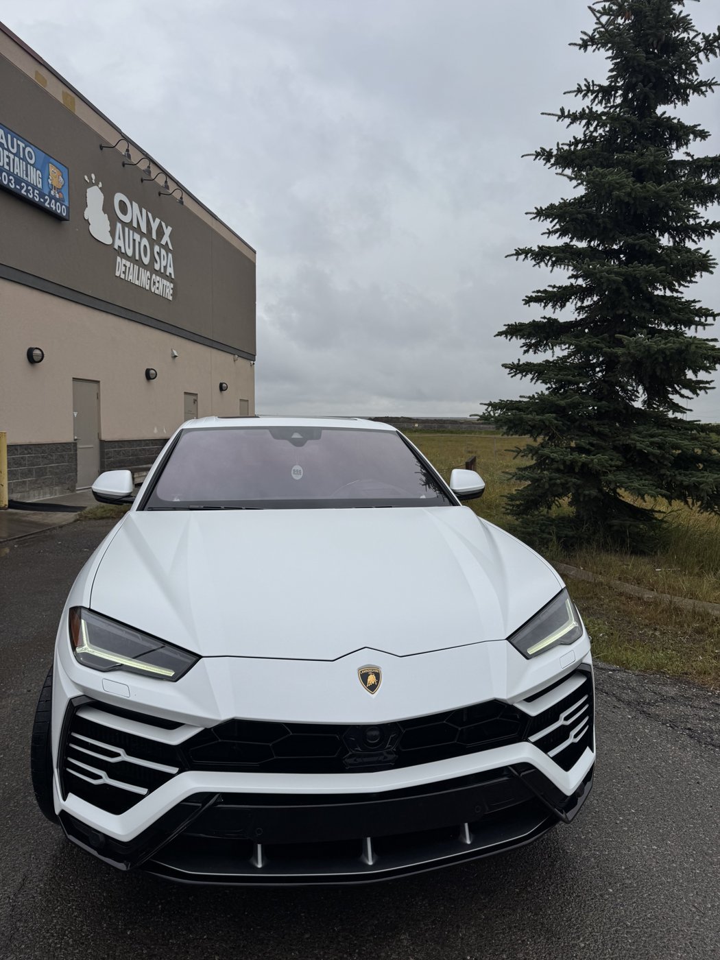 White Lamborghini Urus outside the Onyx Auto Spa detailing centre in Calgary